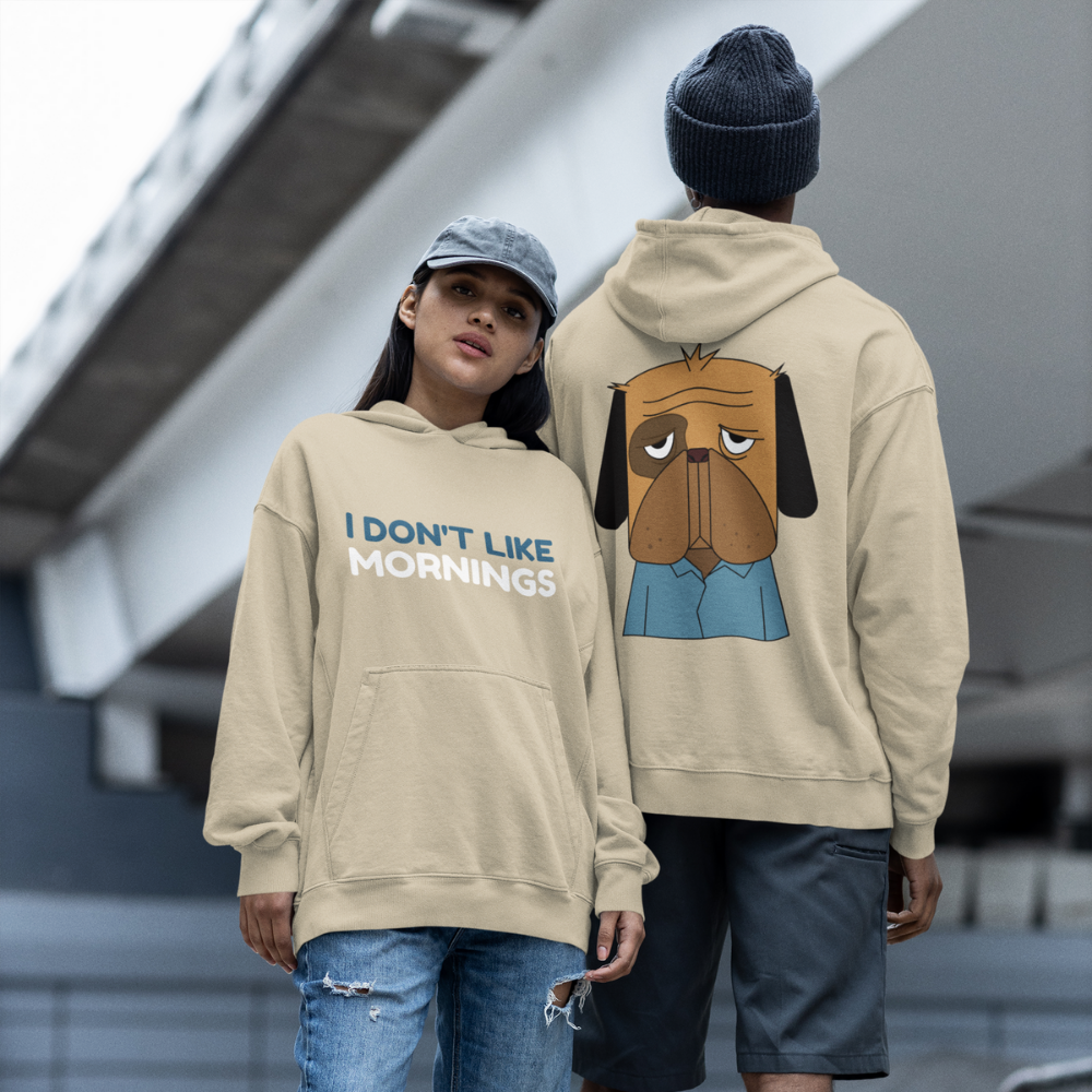 Áo hoodie be in chữ "I DON'T LIKE MORNINGS" và hình chú chó buồn ngủ mặc áo xanh – thiết kế hài hước, dễ đồng cảm.