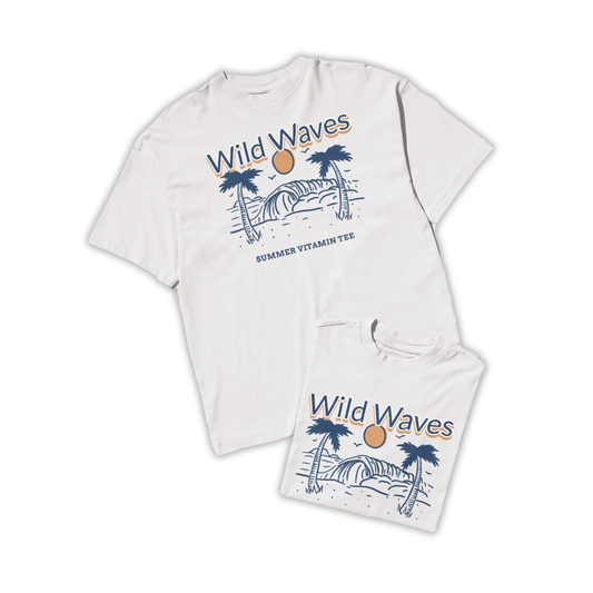 Ảnh áo thun trắng in hình sóng biển, cây dừa và mặt trời cam, dòng chữ "Wild Waves – Summer Vitamin Tee", phong cách tối giản mang vibe mùa hè.