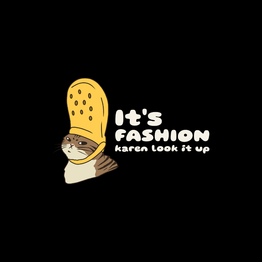 Áo thun unisex đen và đỏ gạch in hình mèo đội Crocs lên đầu, biểu cảm bất cần, slogan “It’s fashion, Karen. Look it up.” – thiết kế meme hài hước, cá tính.