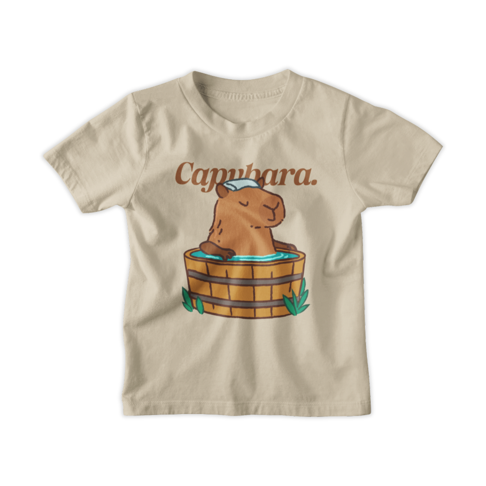 Beige t-shirt with capybara graphic and text on a white background