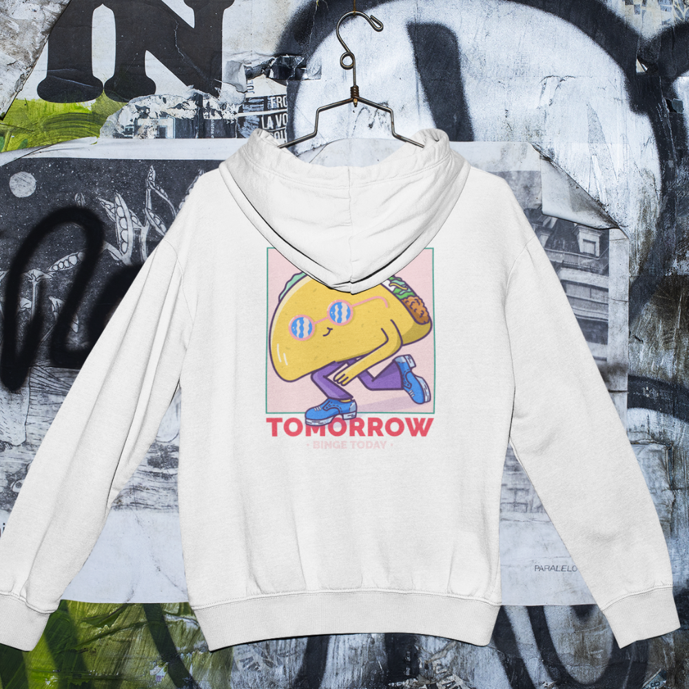 White hoodie with a colorful graphic design on a graffiti-covered wall