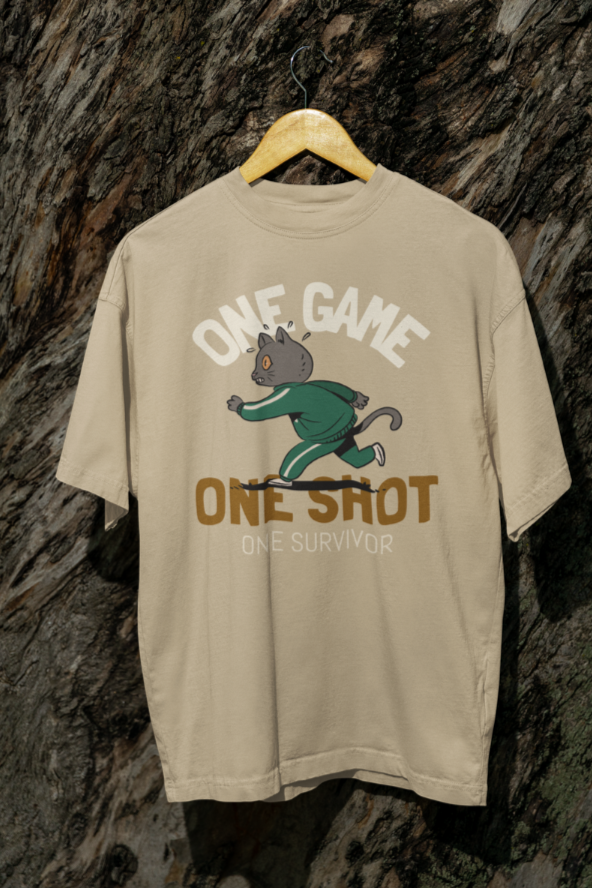 Áo thun màu be in hình mèo chạy mặc đồ Squid Game màu xanh, kèm chữ “One Game, One Shot, One Survivor” và slogan tùy chỉnh