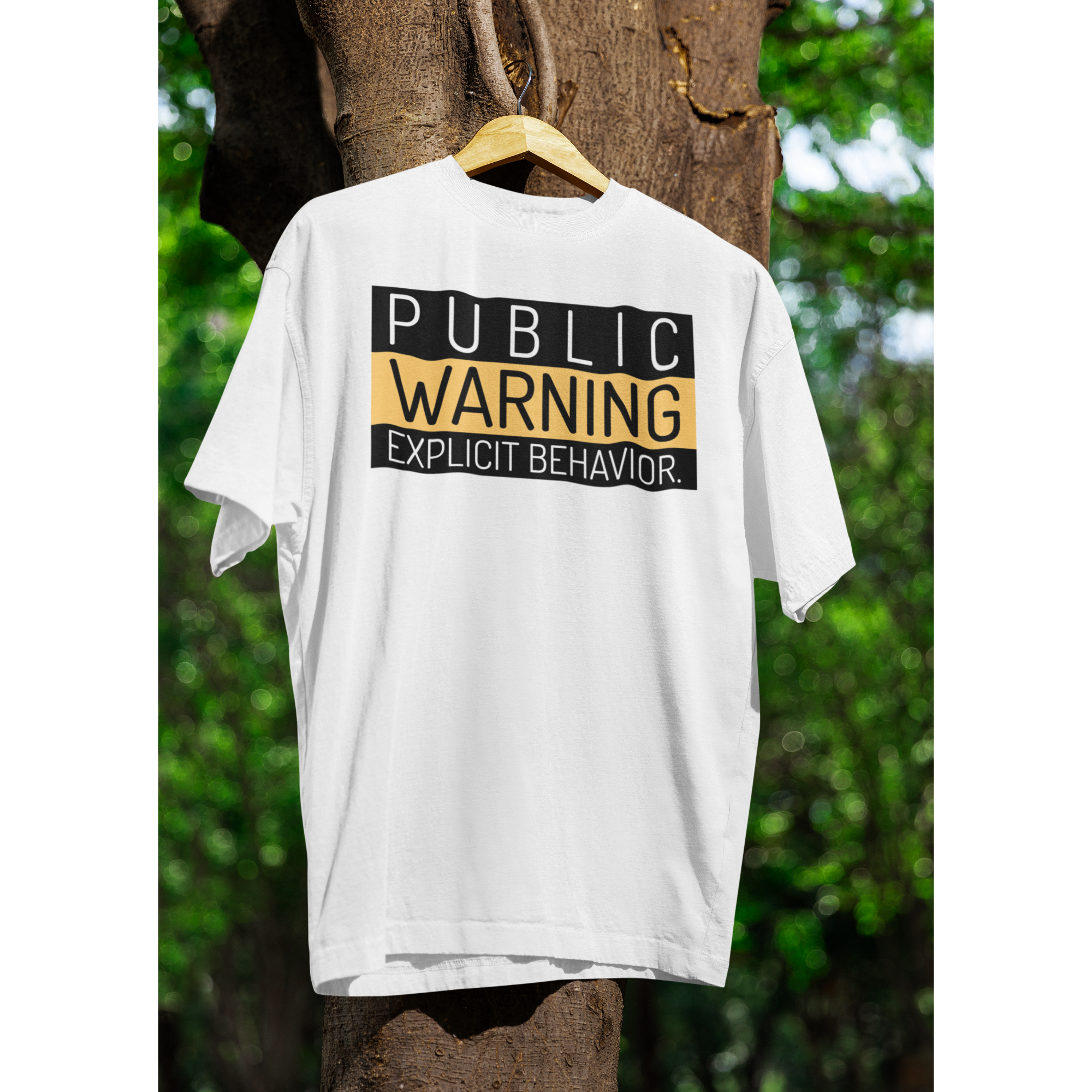 Hai người mặc áo thun trắng in chữ “PUBLIC WARNING: EXPLICIT BEHAVIOR” phong cách streetwear cá tính.