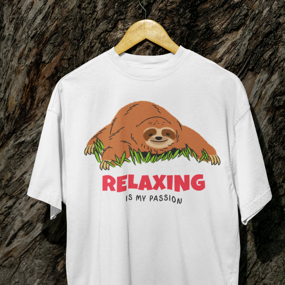White t-shirt with a sloth graphic and 'Relaxing is my passion' text on a wooden hanger against a textured brown background.