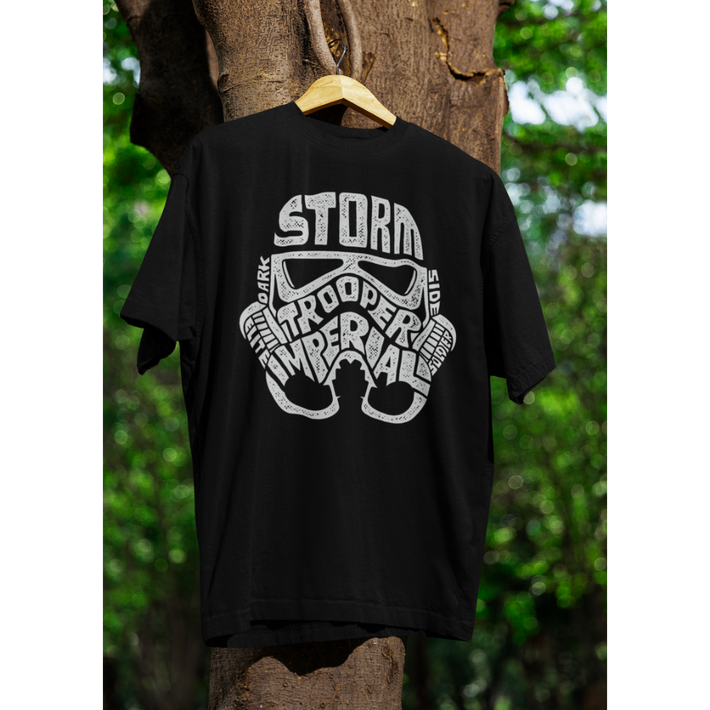 Black t-shirt with white graphic design on a wooden hanger against a natural background