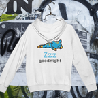 White hoodie with a blue cat illustration and 'Zzz goodnight' text on a graffiti-covered wall background.
