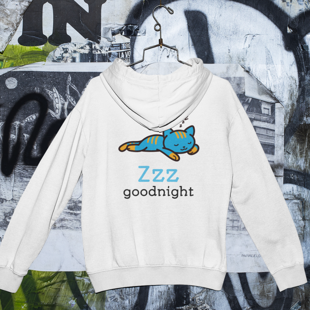 White hoodie with a blue cat illustration and 'Zzz goodnight' text on a graffiti-covered wall background.
