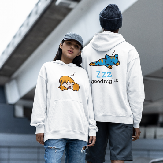 Two people wearing white hoodies with cartoon designs on a city street.